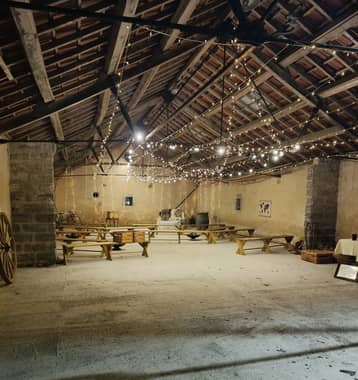 Sous la guinguette, grange éclairée de guirlandes lumineuses